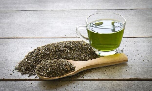loose tea leaves and cup of green tea